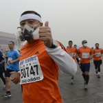 Participants wearing masks during a hazy day at the Beijing International Marathon in front of Tiananmen Square, in Beijing